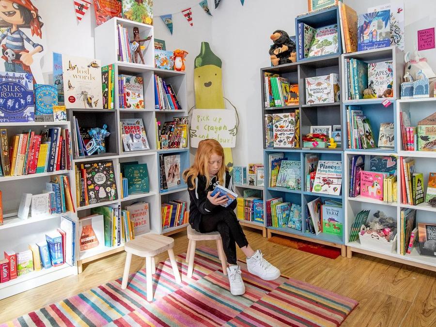 The colourful childrens section with a striped rug, bunting and picture books